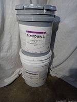 Two stacked pails of Speedwall interior latex paint.
