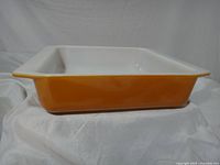 Side profile showing burnt orange exterior and flared rim handle