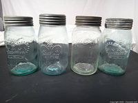 Front view of four Crown Imperial jars showing color differences and embossed logos