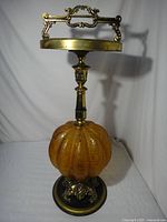 Full view of amber glass and metal ashtray stand