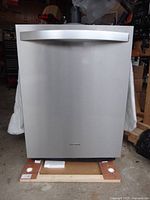 Front view of stainless steel dishwasher on pallet