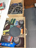 Two drawers showing C-clamps in one and sanding supplies in the other