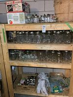 Shelving with multiple rows of glass canning jars, Ball lid box, loose lids