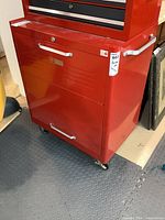 Front view showing drawer, cabinet door, casters, Craftsman badge