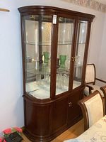 Front view of wood and glass display cabinet with contents inside