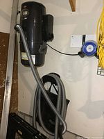 Full view of Bissell Garage Pro unit, hose and accessory rack