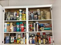 Full cabinet view showing cleaners, lubricants and masking tape