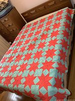 Quilt spread on bed showing full pattern and size