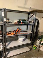 Full view of metal shelving rack with contents present for scale