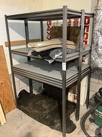 Front view of two stacked metal shelving units with shelves