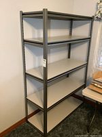 Front view of metal frame shelving unit showing five shelves