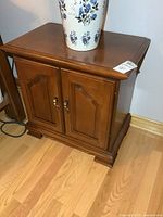 Front view of one nightstand with cabinet doors and hardware