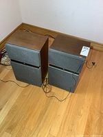 Both Noresco speakers side by side showing overall condition and attached wires
