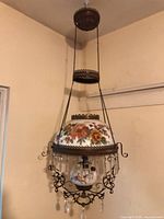 Full view of hanging parlor oil lamp suspended from ceiling
