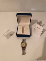 Watch, presentation box, booklet and small bag, overall lot contents