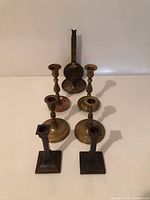 All seven brass candlesticks grouped
