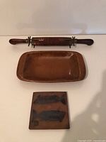 All three items: ceramic platter, cutting tool, printing block