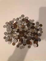 Top view of entire pile of assorted foreign coins