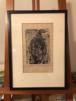 Full view of framed woodcut print on easel