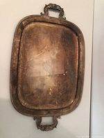 Front of large tarnished silver-plated tray with handles