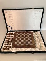 Chess set inside open case showing board and pieces