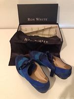 Shoes, box, and shoe bag displayed together