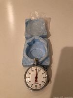 Front view of stopwatch in foam case