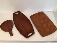 All three wooden trays laid out: paddle, boat, rectangular
