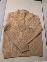 Front view of ivory wool cable knit sweater