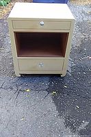 Front view of tan two-drawer nightstand