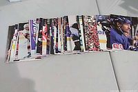 Stack of Panini NHL photo cards spread out on table