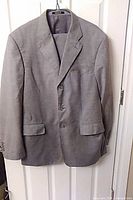 Front view of grey suit jacket on hanger