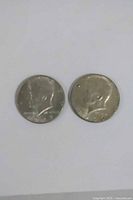 Obverse views of both Kennedy half dollars
