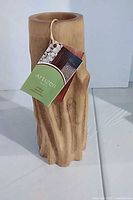 Front view of Artizen mango wood vase with hang tag attached