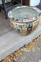 Full view of planter exterior showing shape, decoration, and size perspective