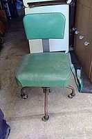 Front view of green vinyl swivel chair