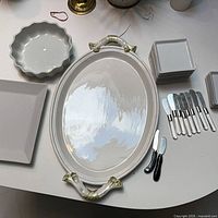 Group showing oval platter, square platter, stacked small plates and spreaders