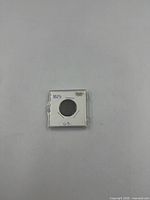 Front view of coin in holder showing 1823 notation