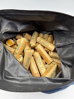 Multiple paper-wrapped nickel rolls inside blue pouch