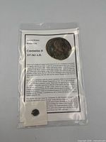 Coin in cardboard flip and info sheet inside clear plastic bag