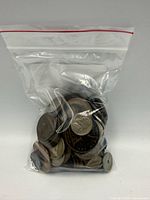 Clear plastic bag filled with assorted coins