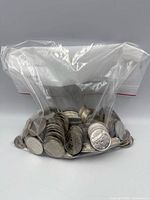 Full view of sealed plastic bag filled with silver-coloured Canadian dollar coins