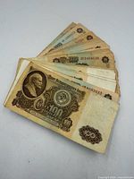 Stack of assorted Soviet banknotes, top note 100 roubles
