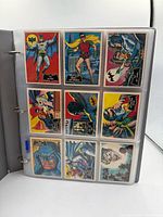 Binder open showing 9 vintage 1966 Batman cards fronts