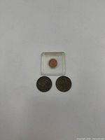 Top view of 1922 cent in holder with two 1852 pennies below