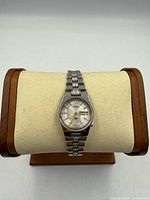 Front view of Citizen stainless steel automatic wristwatch on display stand