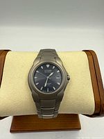 Front view of Citizen Eco-Drive titanium wristwatch on stand