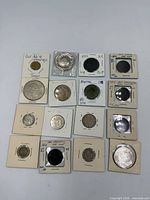 All fifteen coins and token arranged in flips for overview