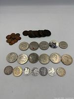 All coins laid out in rows showing obverse designs and size variety