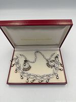 Necklace and earrings displayed in open red box